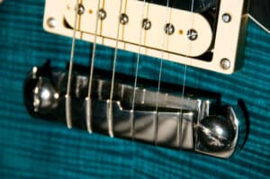 Does a guitars bridge affect its tone